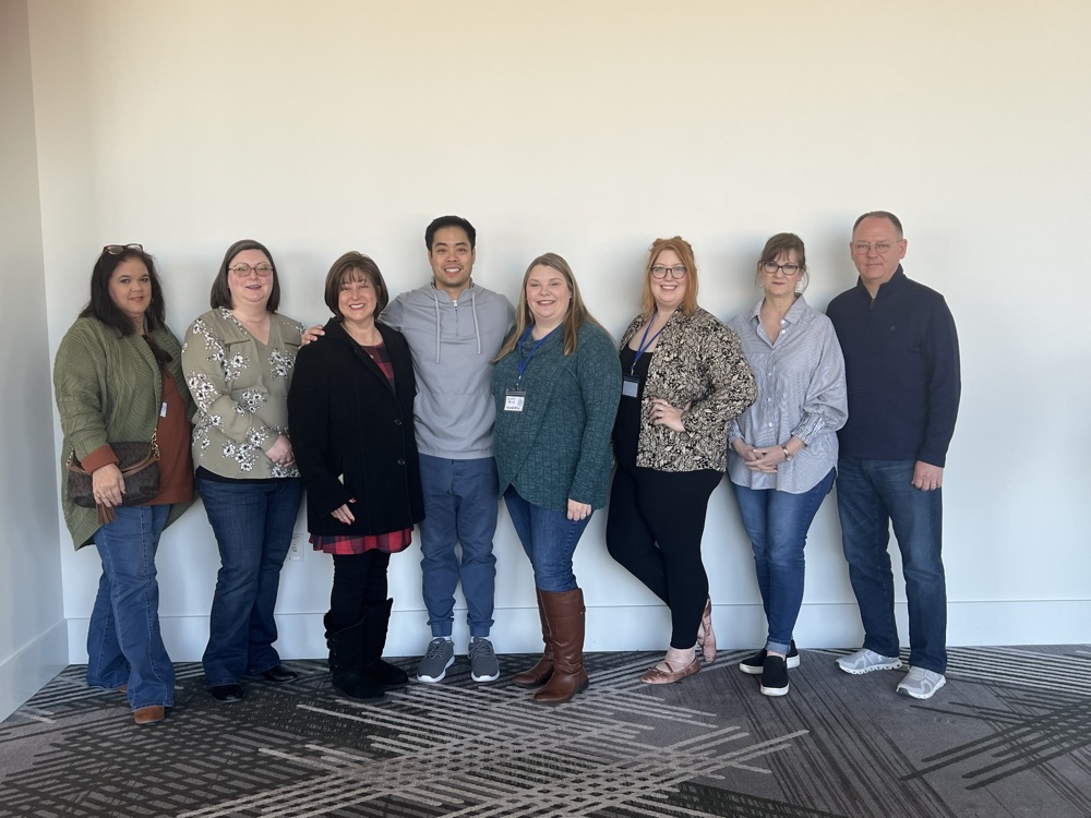 A Suno team member with a group of hearing care professionals